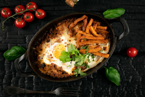 Casserole with beef, onions, cheese and eggs close-up in a pan