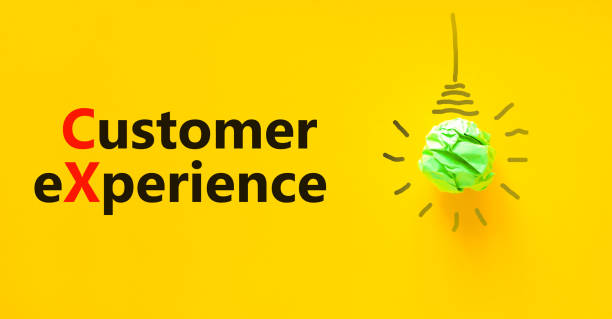 istock CX customer experience symbol. Concept words CX customer experience. Green light bulb icon. Beautiful yellow background. Copy space. Business and CX customer experience concept. 1373004100