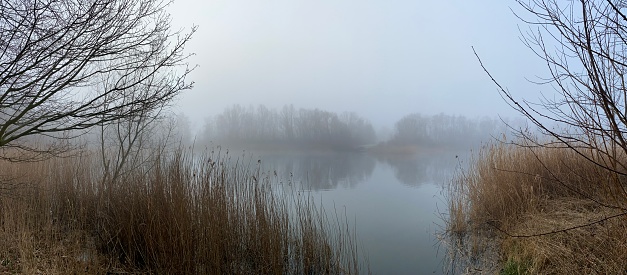 View over the edge of an and cold and misty lake