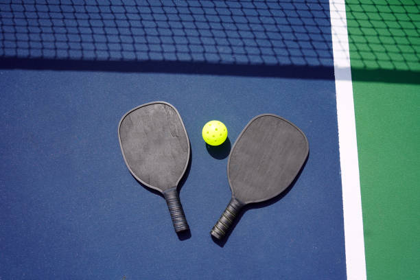 istock Pickle ball paddles on court 1373008173
