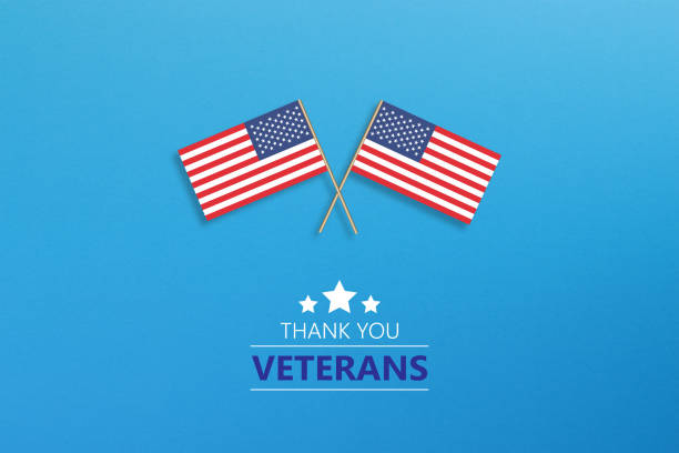 istock Veteran's Day Message with Tiny American Flag Pair on Blue Background 1373008281