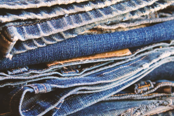 istock A pile of old shabby jeans. Close-up. Background. Texture. 1373008362