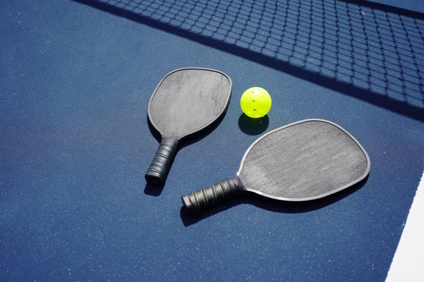 istock Pickleball paddles on court 1373008455