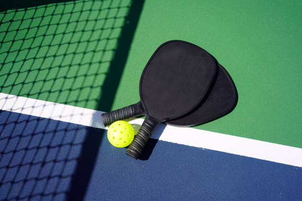 istock Pickleball paddles on court 1373008488