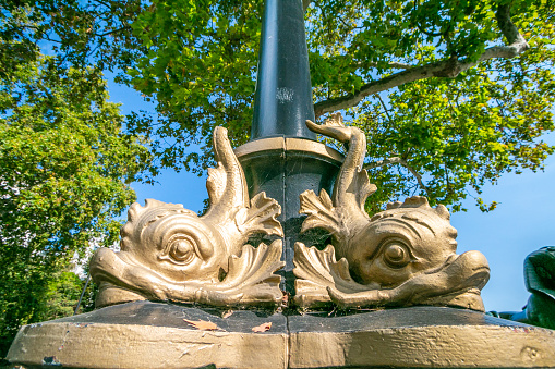 Dolphin (Sturgeon) Lamp Post on Embankment in City of Westminster, London. These were designed in the 19th century by George John Vulliamy and modelled by Charles Henry Driver and  based on dolphin/sturgeon statues at Rome's Fontana del Nettuno in the Piazza del Popolo in Rome.