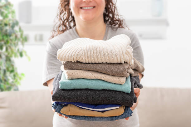 istock woman holding a pile of folded laundry 1373009205