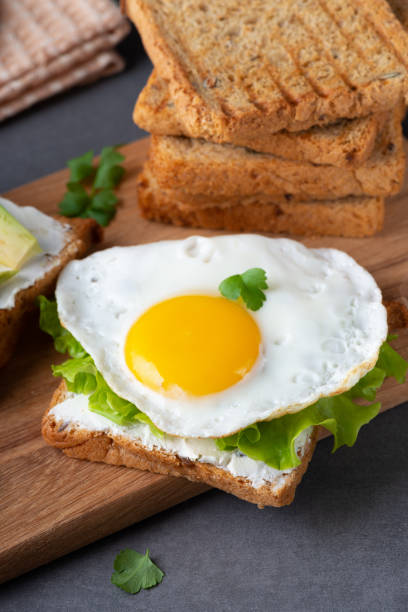 istock Sandwiches with curd cheese, fried egg and herbs 1373013541