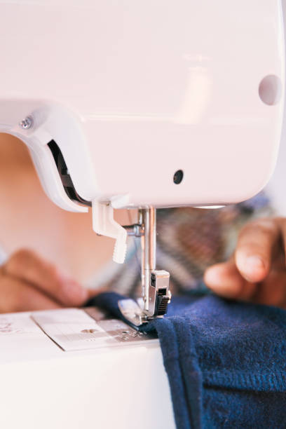 istock unrecognizable woman using a sewing machine to manufacture clothing. Employment issues 1373015708