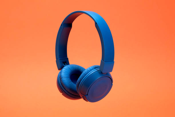 Headphones on the orange color background stock photo