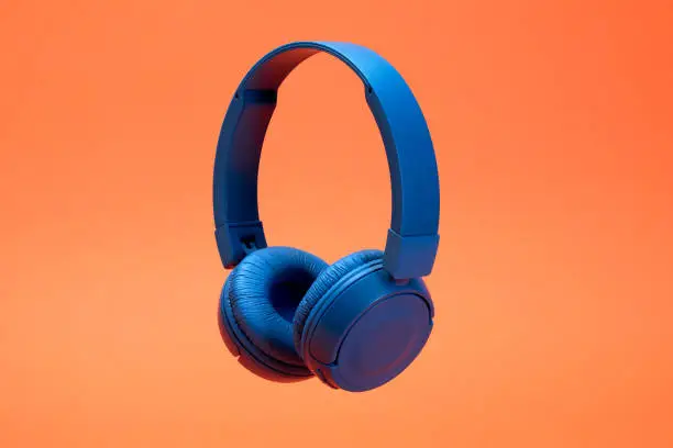 Photo of Headphones on the orange color background