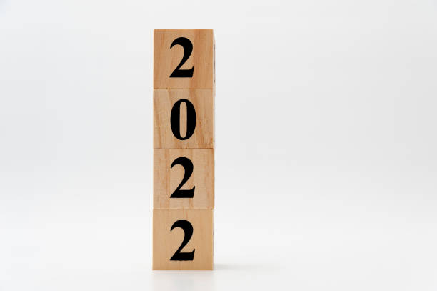 istock 2022 written on wooden blocks in vertical direction isolated on white background with copy space 1373018589