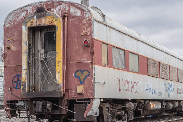 Lockport, New York, United States - December 22, 2021:  Abandoned weathered and graffitied passenger rail carriage at a railway siding