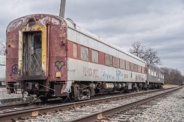 Lockport, New York, United States - December 22, 2021:  Abandoned weathered and graffitied passenger rail carriage at a railway siding
