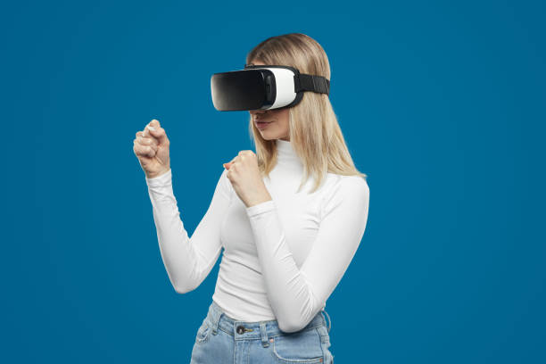 istock Woman playing videogame in VR glasses 1373029039