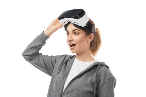 istock Amazed woman in VR headset on white background 1373029048