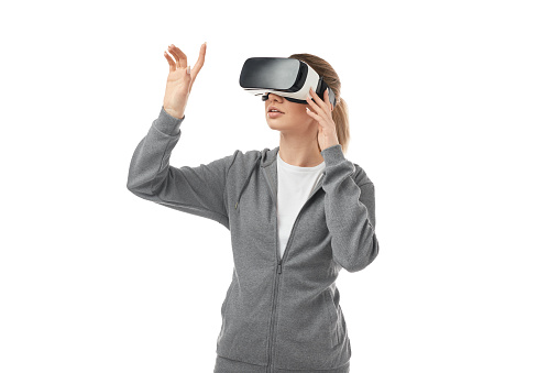 Female in modern VR headset touching screen and exploring cyberspace on white isolated background