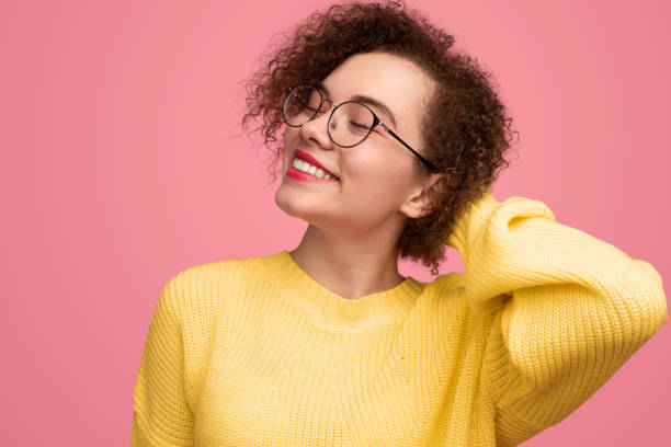 istock Cheerful curly haired woman on pink background 1373029118