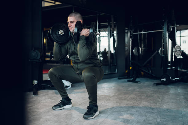 istock Man training in the gym and using dumbbells 1373029783