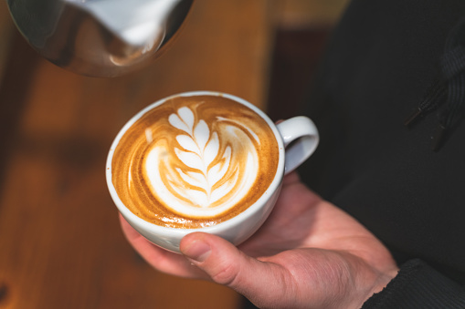 Barista make coffee cup latte art