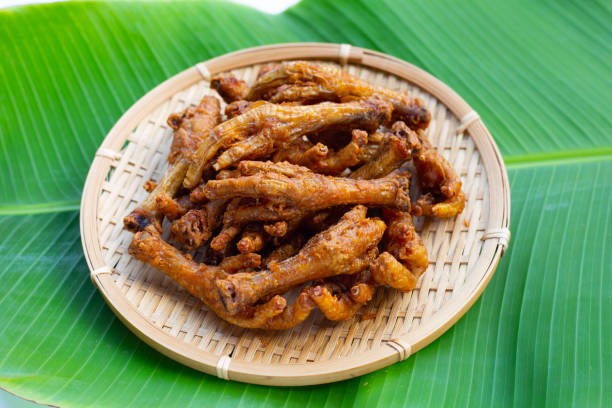 istock Fried chicken feet in bamboo basket on banana leaf 1373038096