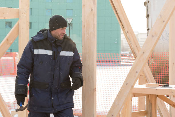 istock Worker assembling the frame of a wooden slide 1373039660