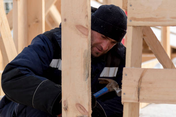 istock Worker assembling the frame of a wooden slide 1373039663