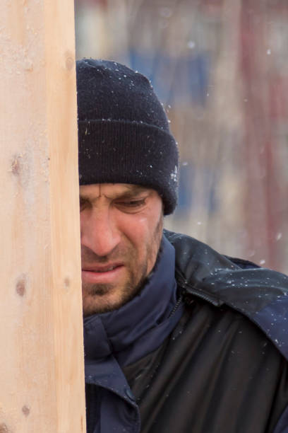 istock Worker assembling the frame of a wooden slide 1373039680