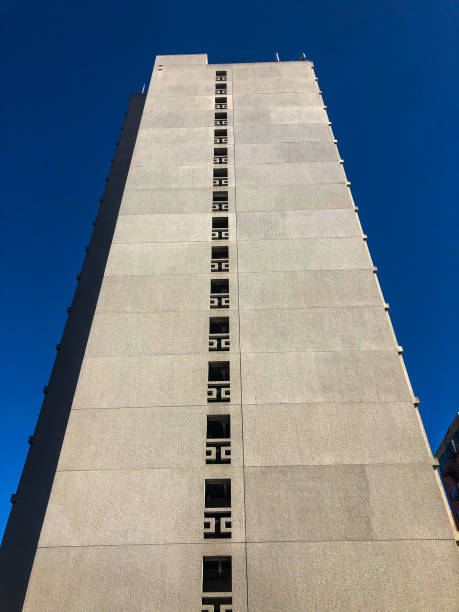 istock Looking up at tall skyscraper toward blue sky 1373039794