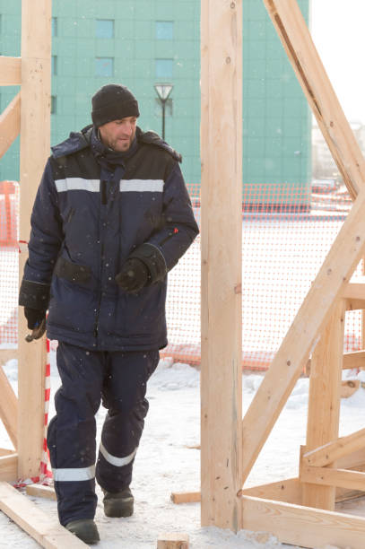 Worker assembling the frame of a wooden slide