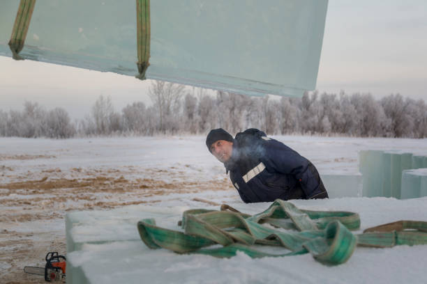 istock Portrait of a slinger in a blue jacket unloading ice blocks 1373040466