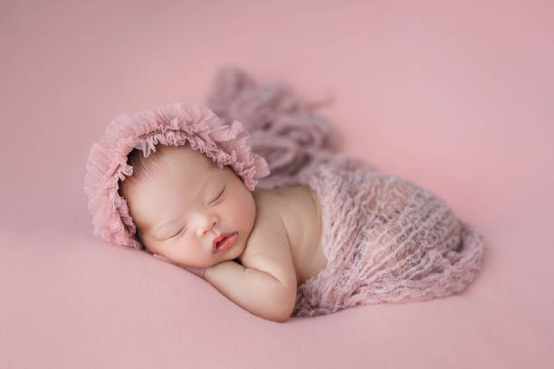 Asian newborn baby sleeping Happy adorable cute Asian newborn baby sleeping on pink background baby girls stock pictures, royalty-free photos & images