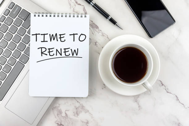 istock Time to renew phrase on notepad with cup of coffee and laptop 1373049467