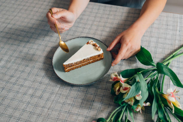 unrecognizable white woman enjoying a slice of birthday cake - thirty pieces of silver imagens e fotografias de stock