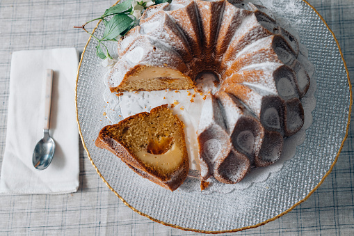 A close up shot of a delicious dessert, a bundt cake on an elegant plate.