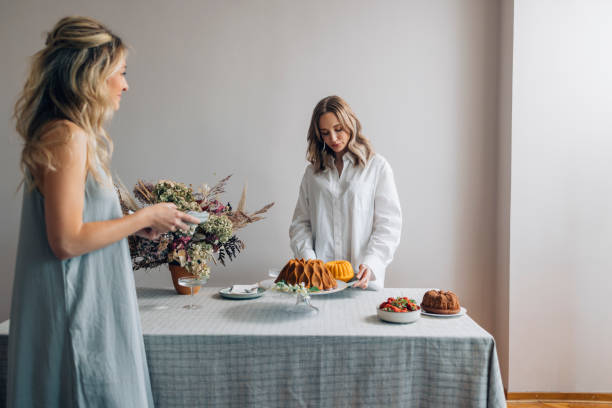 istock Two Smiling Female Friends Having Fun while Setting up the Table for a Birthday Party 1373050249