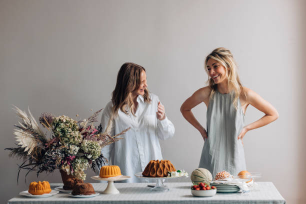 istock Two Smiling Female Friends Having Fun while Setting the Table for a Birthday Party 1373050277