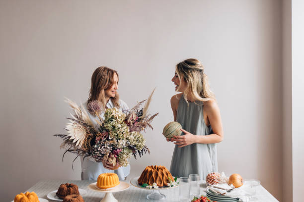istock Two Smiling Female Friends Having Fun while Setting the Table for a Birthday Party 1373050299