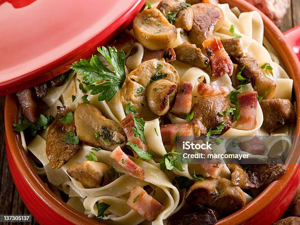 Tagliatelle With Cep Edible Mushroom And Bacon Over Casserole Stock Photo - Download Image Now