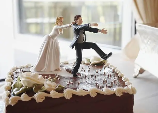 Funny wedding cake top, bride chasing groom 
