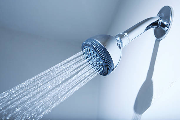 Shower Shower head with water stream on blue background shower head stock pictures, royalty-free photos & images