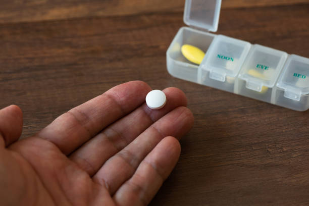 istock Medication on hand and drug container 1373058340