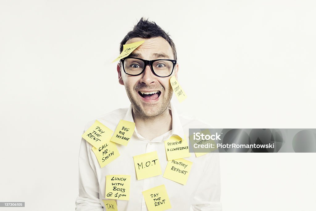 Stressed and depressed office worker with post-it notes. Young stressed and overworked white collar worker with post-it notes. Adhesive Note Stock Photo