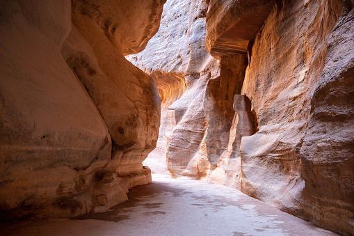 The Siq is a natural fissure in the layered sandstone rock creating a spectacular route to enter the ancient carved city of Petra in Jordan