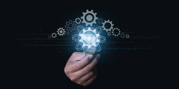istock Businessman hand holding light bulb with a gear icon. 1373064822