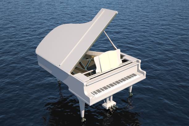 white piano in the ocean stock photo