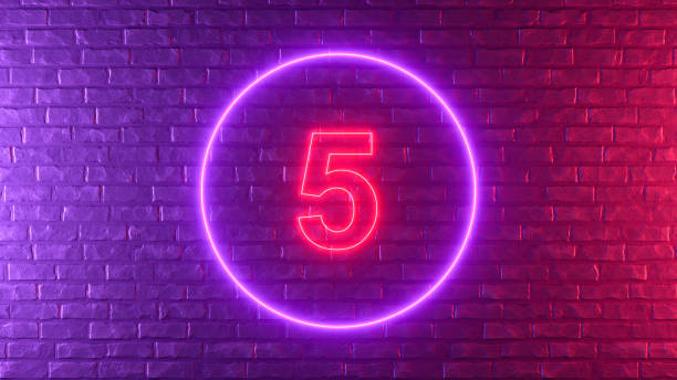istock Number 5 with glowing neon lighting on black brick wall 1373077968