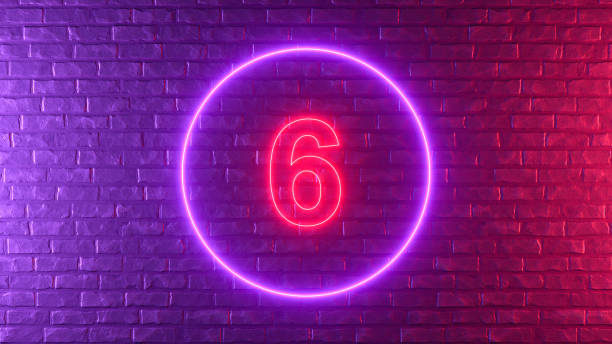 istock Number 6 with glowing neon lighting on black brick wall 1373078161