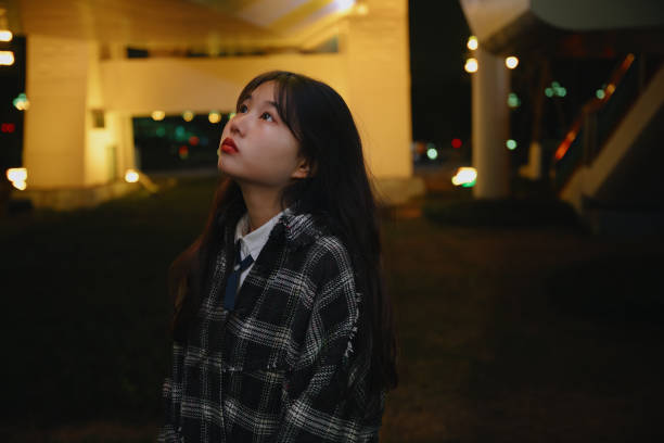 istock Asian young women on the bridge at night 1373079538