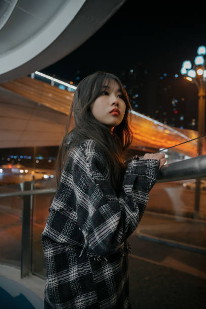 istock Asian young women on the bridge at night 1373079620