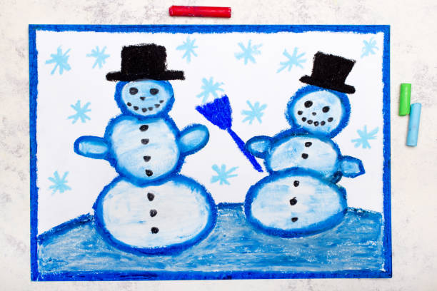 Close-up of a snowman Christmas decoration wearing a knitted blue hat and scarf, placed outdoors against a wooden wall.